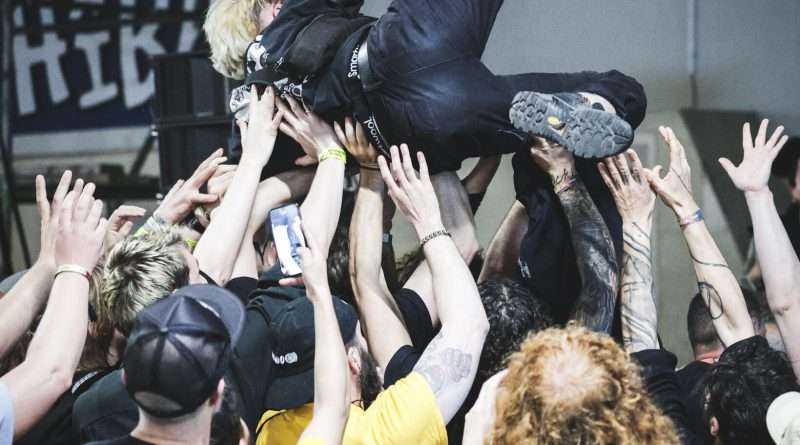 Crowd surfing during a live performance at Roadburn Festival, representing underground metal culture.